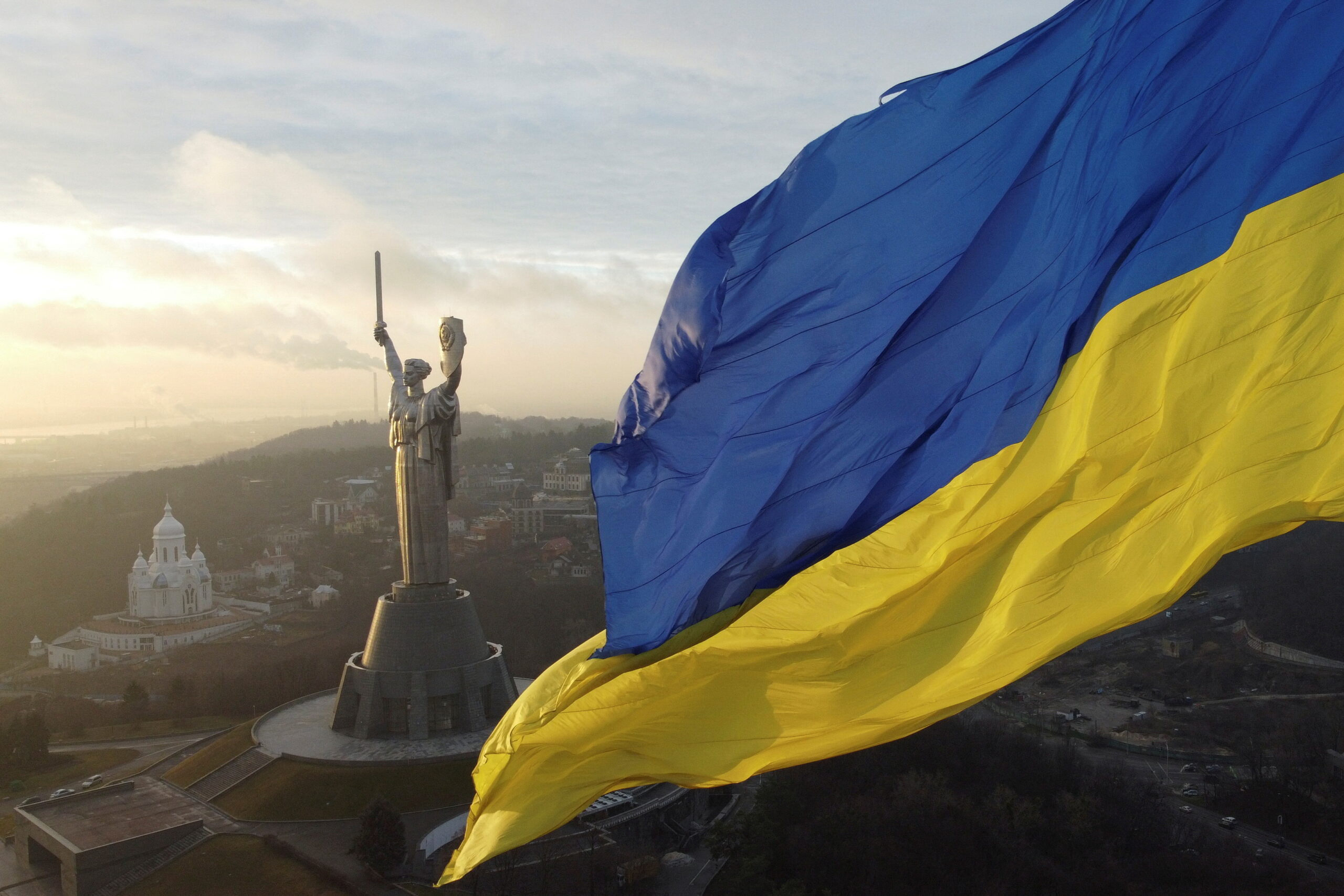 Ukraine's Flag, which is a thick blue stripe on top of a thick yellow stripe, blowing in the wind.