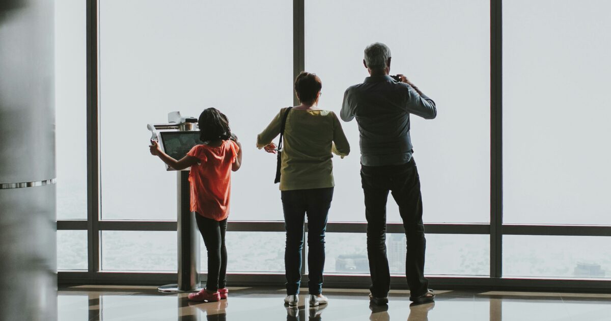 Grandparents and a child at the airport, visiting Canada.
