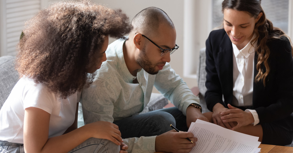 Couple reviewing documents with a notary