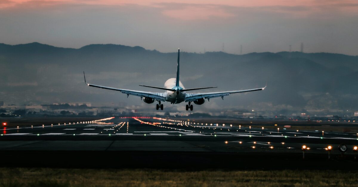 The back view of an airplane taking flight