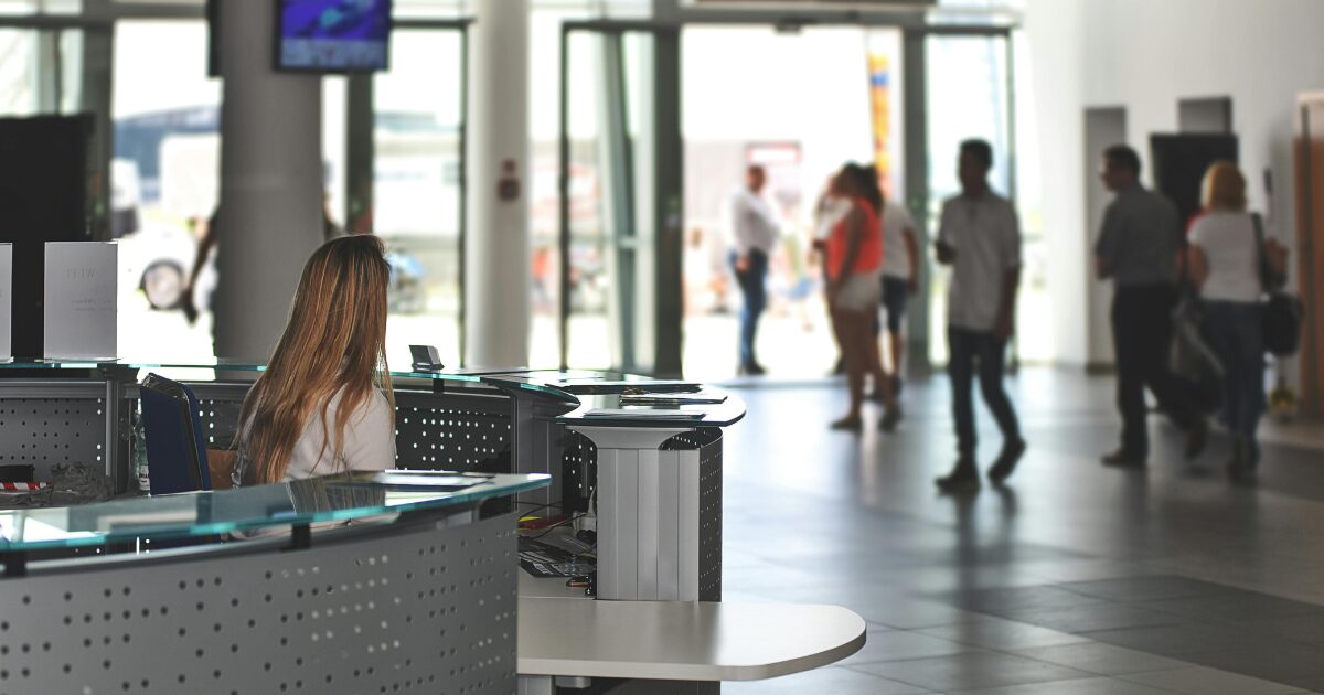 Immigration authority working at a customs desk, waiting to help travelers.