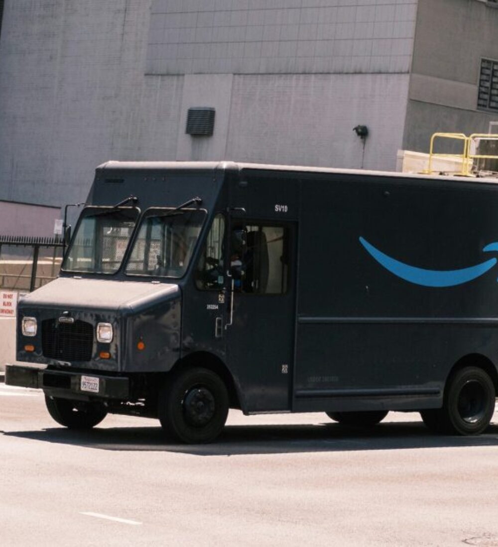 Large dark gray company delivery van on the road.