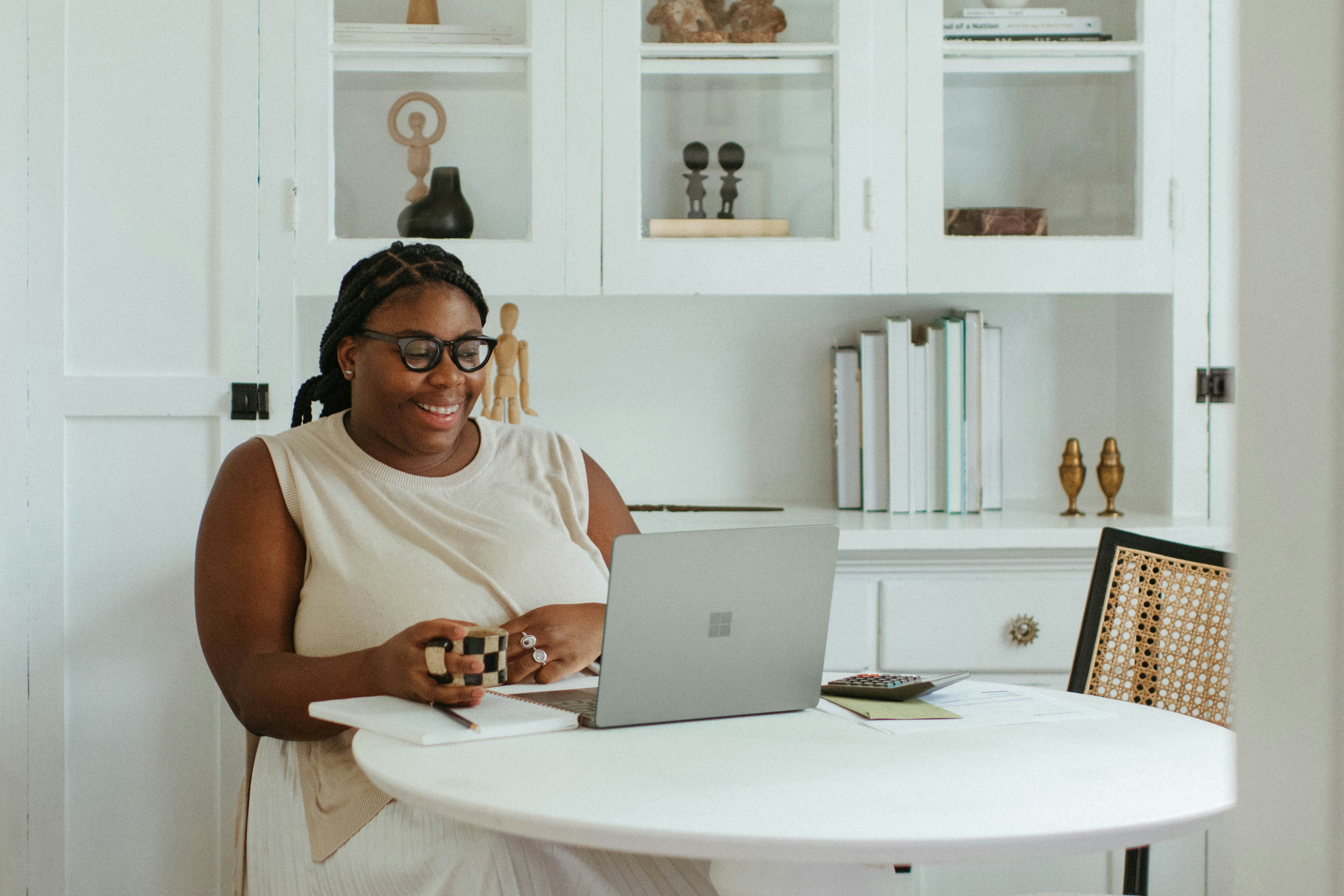 black woman in her 30s reviewing a document at a clean white desk